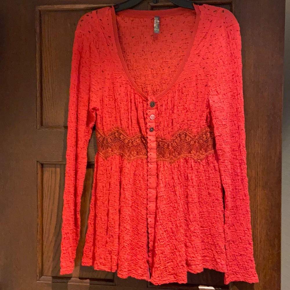 Free People red- orange colored blouse with lace.